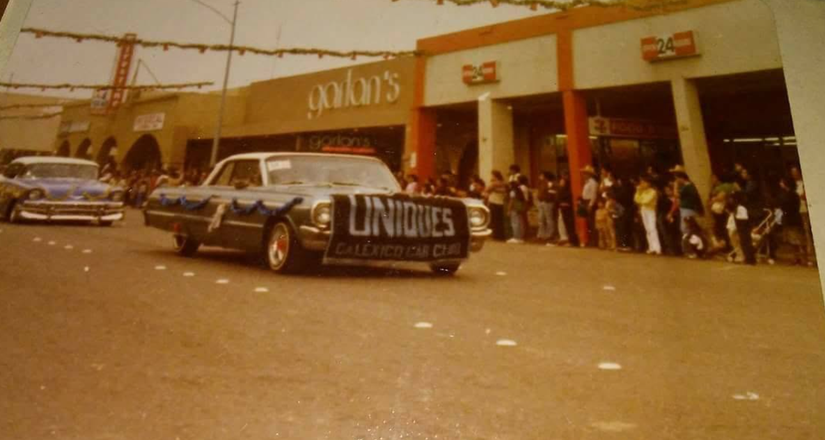 Historic Uniques Car Club lowriders driving in a Calexico parade